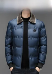 Detail of winter puffer jacket with grey faux fur collar and quilted navy blue windproof fabric