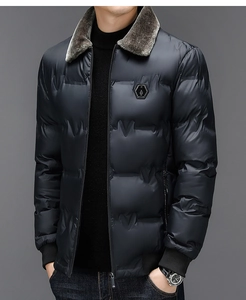 Detail of men's quilted winter jacket featuring a plush grey fur collar and hex badge