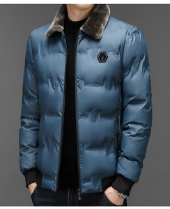 Close-up of winter jacket featuring dark faux fur collar and hexagonal chest logo detail