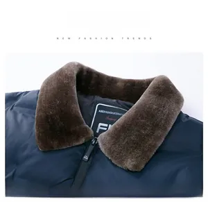 Detail of navy blue men jacket with brown faux fur collar and smooth zip fastening