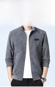 Detail of grey corduroy casual jacket featuring a stand collar and black decorative chest patch