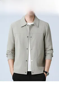 Detail of light grey men's jacket showing waffle texture fabric and silver metal snap buttons