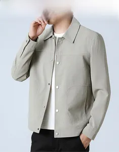 Close-up of light grey men's jacket featuring waffle texture fabric and silver buttons