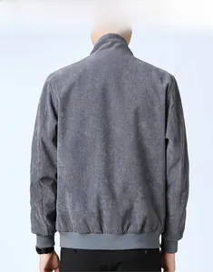 Detail view of the back of a grey corduroy jacket with ribbed hem and stand-up collar