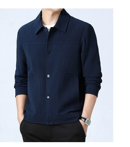 Detail of navy blue waffle texture men's jacket with snap buttons and lapel collar