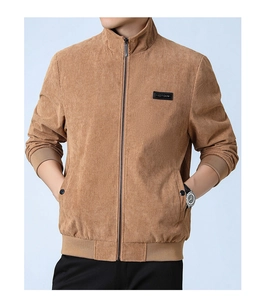 Detail of tan corduroy jacket featuring stand collar and ribbed hem on male model