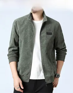 Detail of dark green corduroy jacket texture featuring ribbed collar and zipper closure