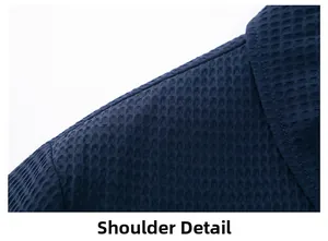 Macro detail of navy blue jacket shoulder showing textured waffle knit fabric