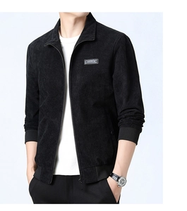 Detail of black corduroy jacket with ribbed cuffs, zip closure and square chest patch