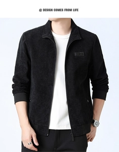 Close-up of black corduroy jacket showing ribbed texture, collar and leather chest label