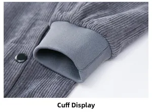 Detail of gray corduroy jacket showing ribbed elastic cuffs and black metallic snap button