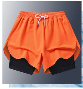 Detail of men's double-layer sports shorts with orange outer fabric and black inner lining