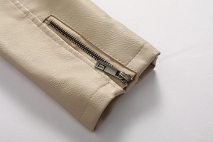 Close-up of cream leather jacket cuff with metal zipper and premium stitching details