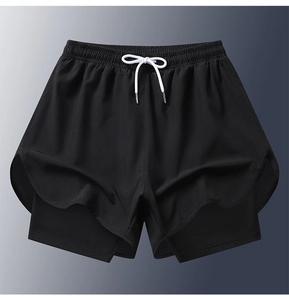 Detail of black double-layer athletic shorts featuring quick-dry fabric and drawstring waist