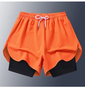 Detail of orange 2-in-1 shorts with scalloped edge and black compression liner for running