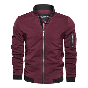 Detail of the bomber jacket zipper pocket and elastic cuffs on wine red fabric