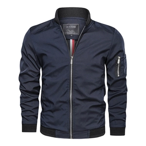 Detailed view of dark blue bomber jacket with rib-knit collar and arm zipper pocket