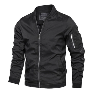 Macro view of a black bomber jacket showing rib-knit collar and tactical sleeve pocket