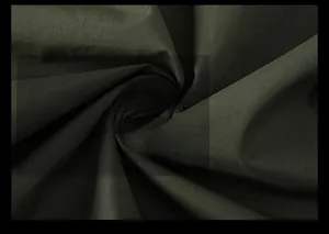 Macro shot of dark green functional fabric with durable, soft, and wrinkle-resistant texture