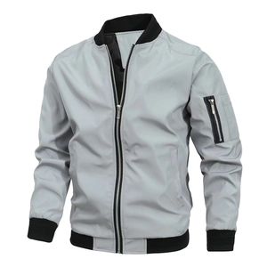 Detail of grey bomber jacket showing windproof fabric with black ribbed collar and pocket