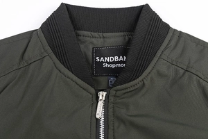 Detail of the military green bomber jacket ribbed collar and metal zipper closure