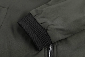 Macro shot of knitted elastic cuffs and metal zipper on military green pilot jacket