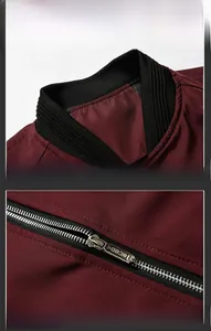 Detail of burgundy flight jacket featuring ribbed collar and smooth metal zipper closure