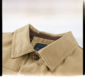 Detail of khaki jacket lapel with metallic FASHION button and durable cotton fabric