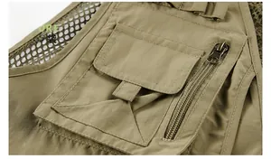 Detailed close-up of khaki outdoor fishing vest pocket with metal zipper and mesh