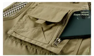 Detail of khaki outdoor vest showing a functional zipper pocket holding a smartphone