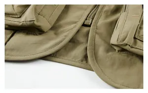 Detail of reinforced stitching and large flap pockets on the khaki outdoor fishing vest