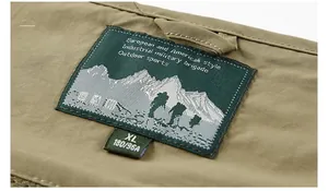 Detail view of the olive green outdoor vest neckline with embroidered military style label