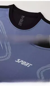 Detail of blue and black sportswear T-shirt showing collar tag and SPORT print texture