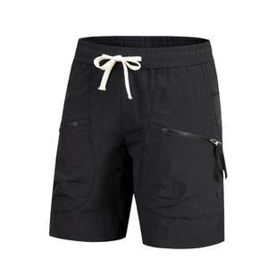 Detail of black quick-dry shorts with elastic drawstring waist and side zipper pockets