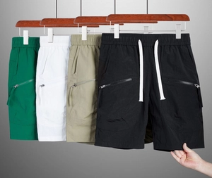 Detail of men's quick-dry shorts featuring elastic waistband and zipper pockets