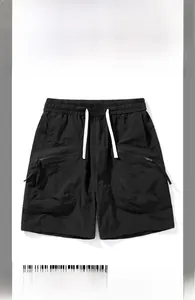 Detail of men's quick-dry cargo shorts featuring elastic waistband and large zipper pockets