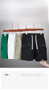 Detail of summer quick-dry shorts featuring elastic waistband and secure zipper pockets