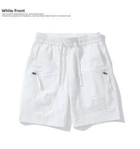 Detail of white shorts with elastic waistband drawstring and functional zippered side pockets