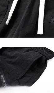 Detail view of black summer athletic shorts featuring texture drawstrings and side pockets
