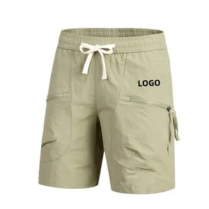 Detail of light green quick-dry shorts with elastic waistband and zipper pockets