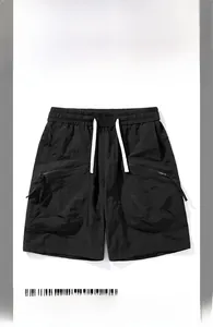 Detail of black quick-dry cargo shorts featuring elastic waist and white drawstrings