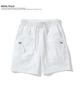 Detailed view of elastic waist with drawstring and zipper pockets on white cargo shorts