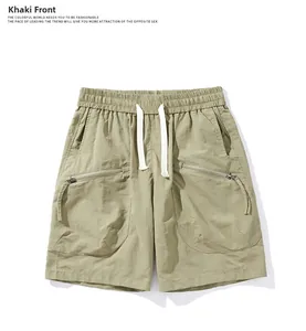 Front detail of khaki cargo shorts with elastic drawstring waist and zip pockets
