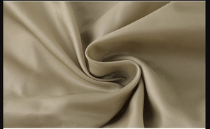 Detail of khaki twill fabric texture with silk-like sheen for flight bomber jacket