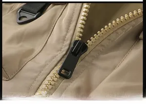 Detailed macro view of khaki pilot jacket resin zipper with high-density twill texture