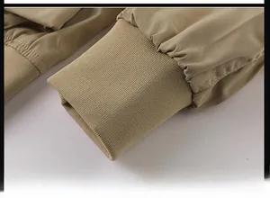 Close-up of ribbed knit cuffs on a khaki pilot bomber jacket with windproof fabric