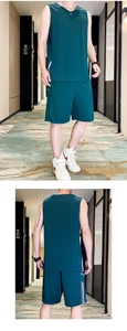 Detailed view of dark green men's athletic set with tri-color side stripes and quick-dry fabric