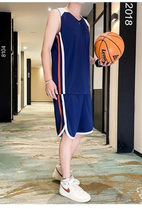 Detail of breathable mesh basketball jersey set in navy blue with orange side stripes