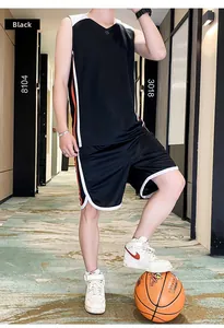 Close-up of black breathable men basketball jersey and shorts with side stripe detail