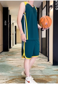 Detail of loose fit basketball jersey and shorts set in dark green with side stripes